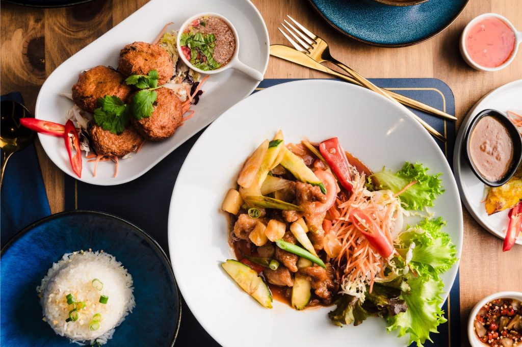 A selection of Thai food including jasmine rice, and thai fishcakes.