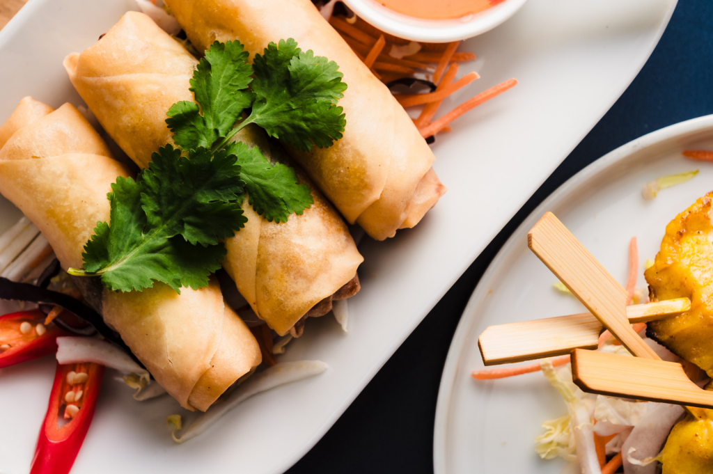 thai spring rolls and chicken satay skewers