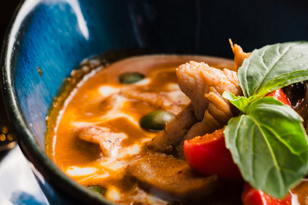 side view of a chicken panang curry.